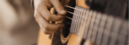Musician playing an acoustic guitar