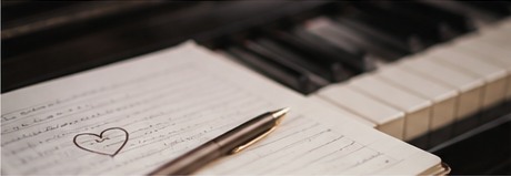 Romantic handwritten notes beside a piano